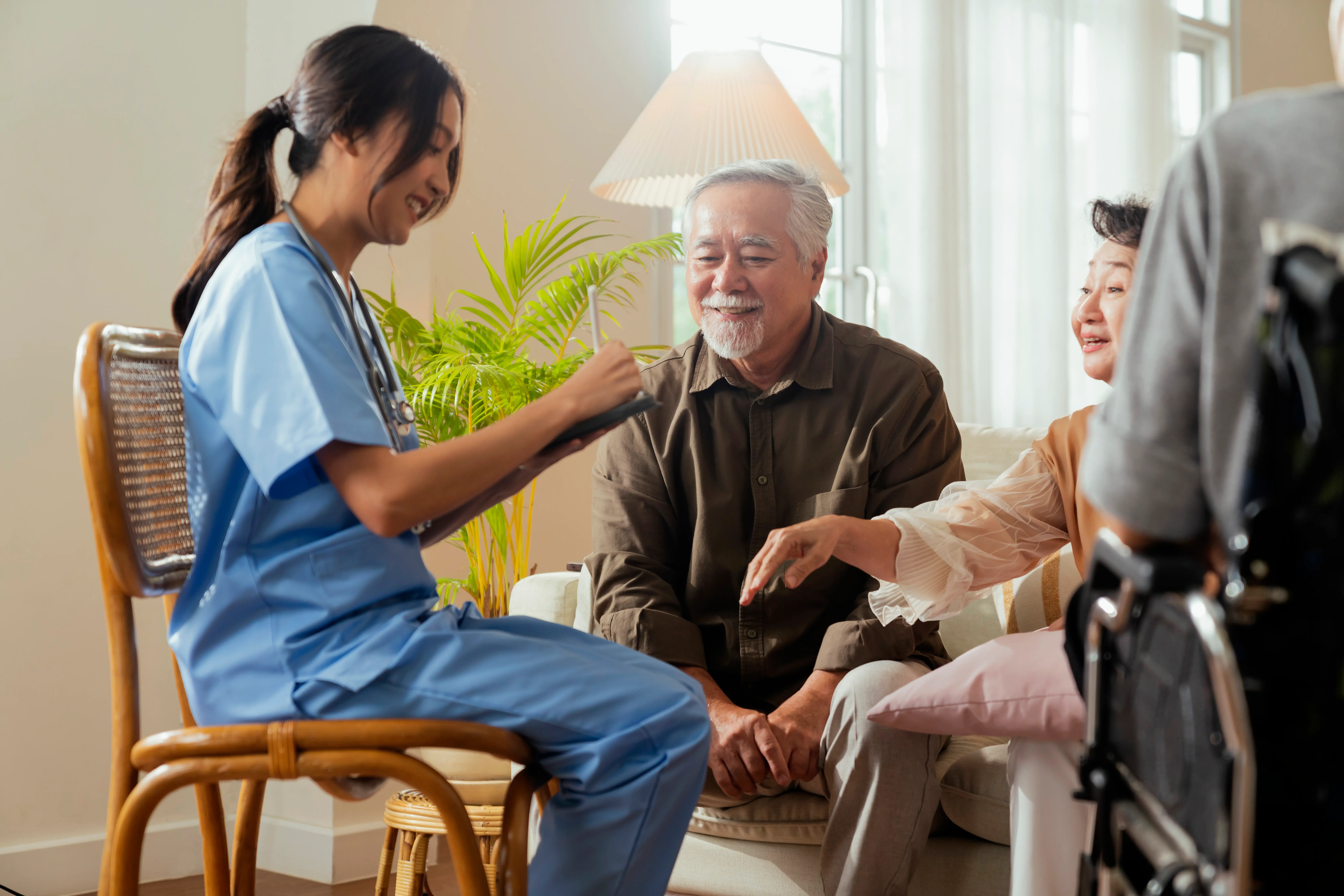 A caregiver holding the hands of an elderly person